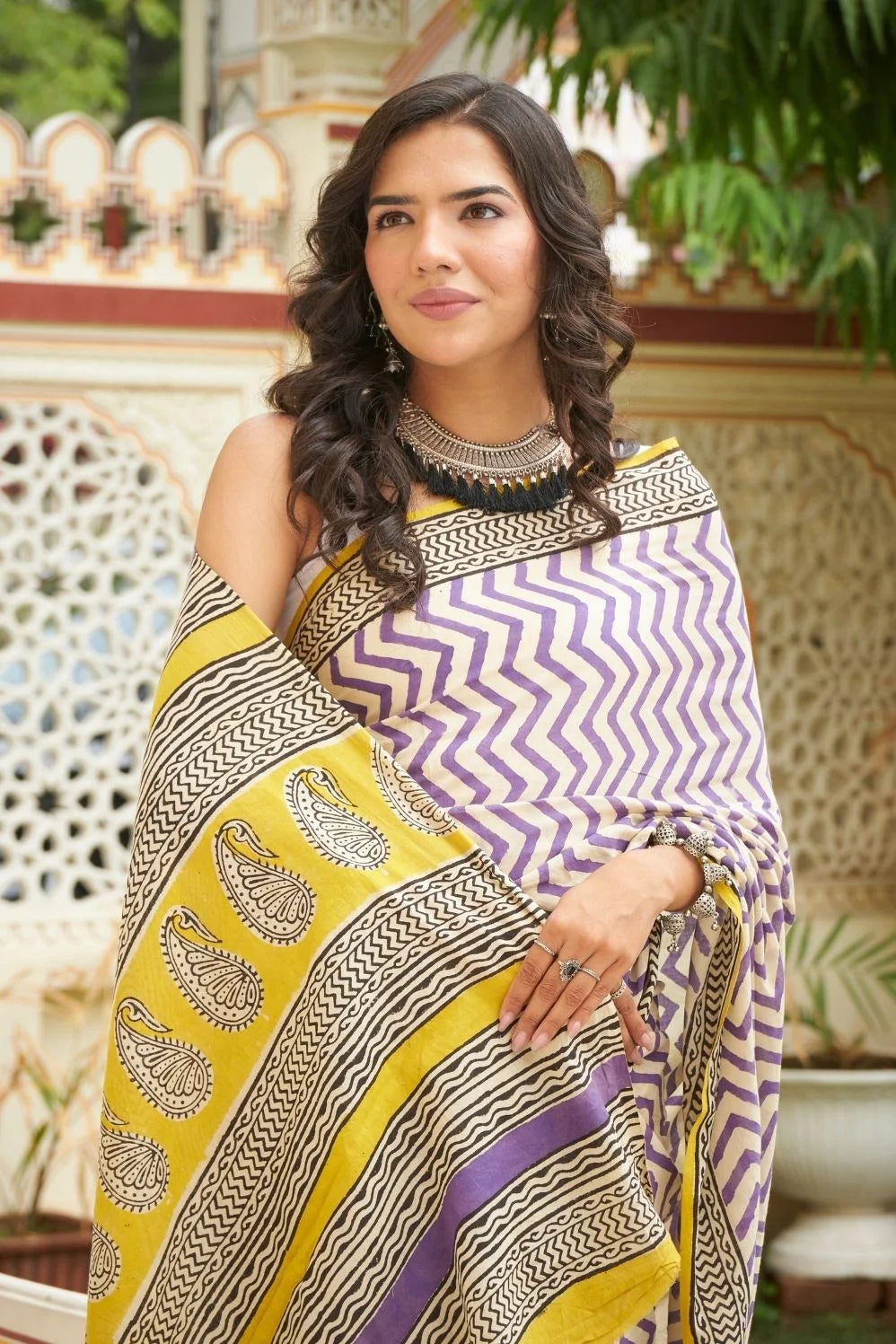 White and purple mulmul cotton saree with artistic block prints.