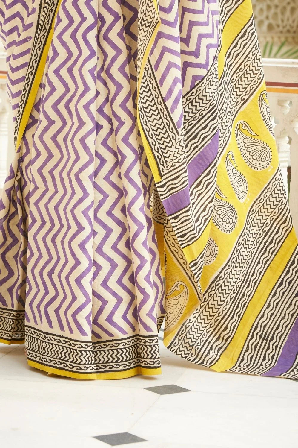 White and purple mulmul cotton saree with artistic block prints.
