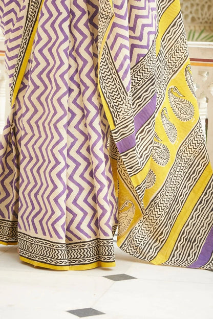 White and purple mulmul cotton saree with artistic block prints.