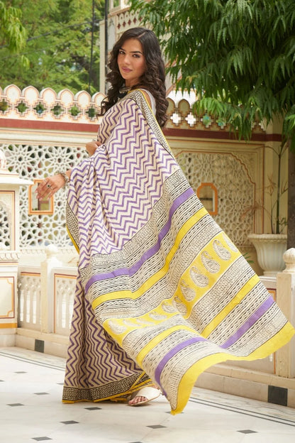 White and purple mulmul cotton saree with artistic block prints.