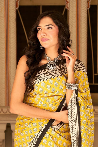 Yellow mulmul cotton saree with traditional hand block prints.