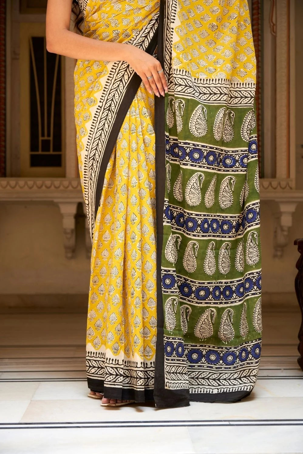 Yellow mulmul cotton saree with traditional hand block prints.