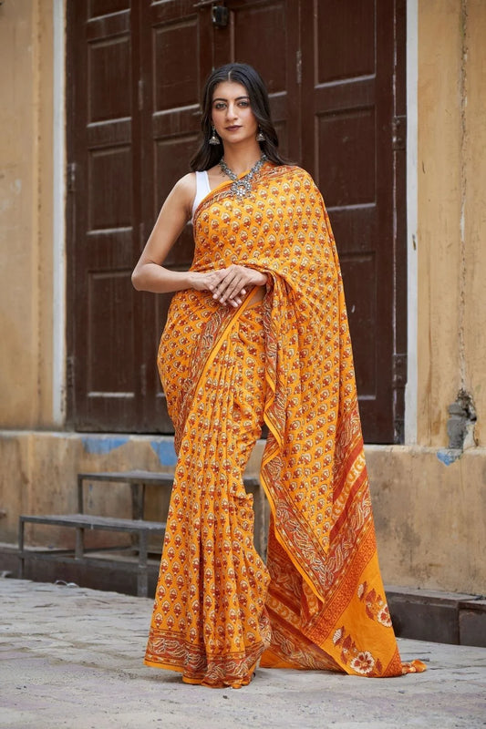 Yellow mulmul cotton saree with traditional hand block prints.