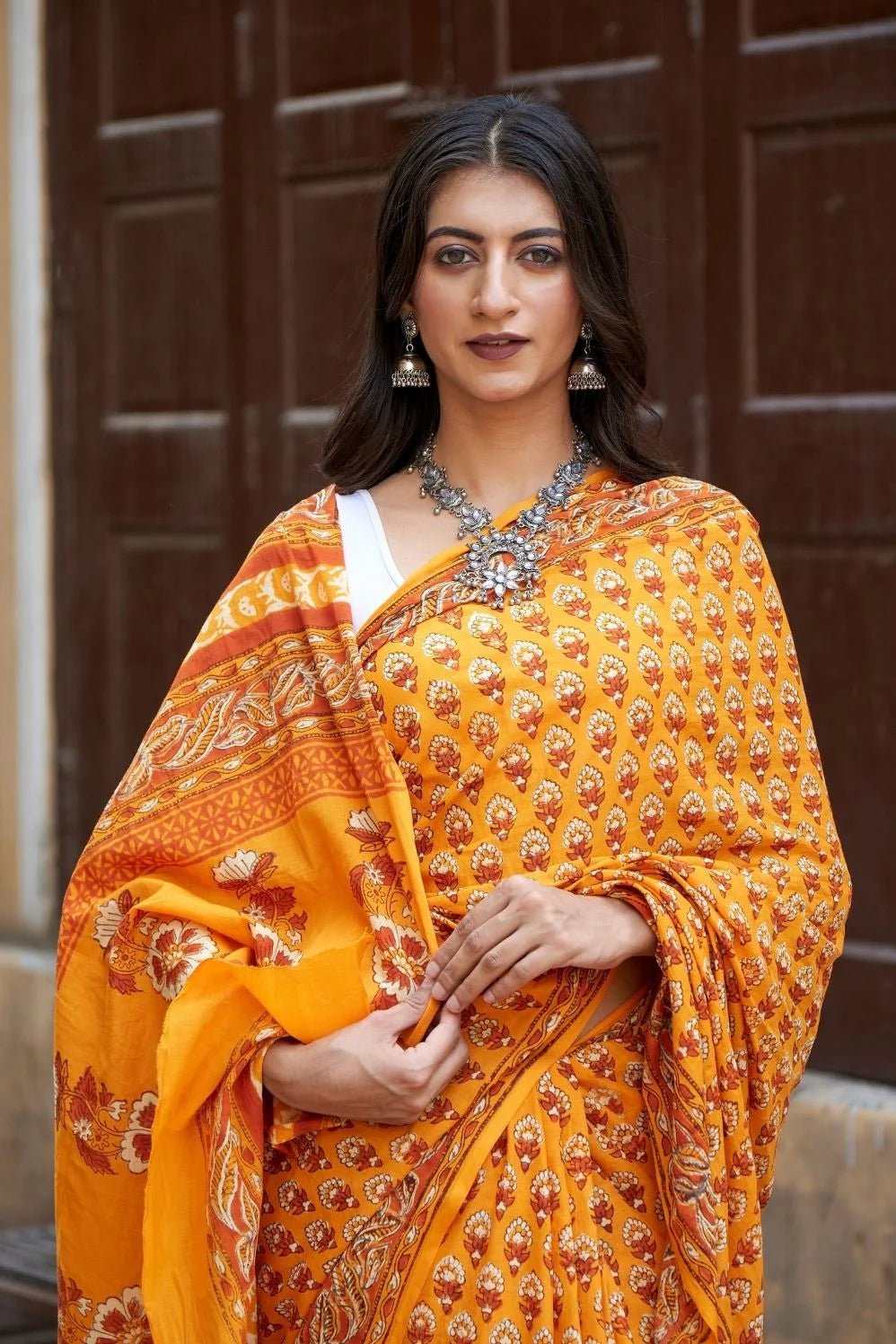 Yellow mulmul cotton saree with traditional hand block prints.